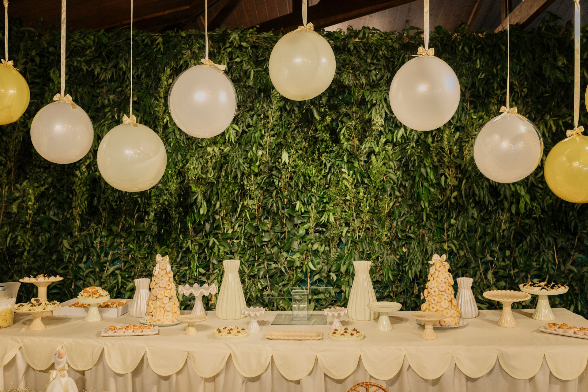 Mesa de doces com parede verde e balões